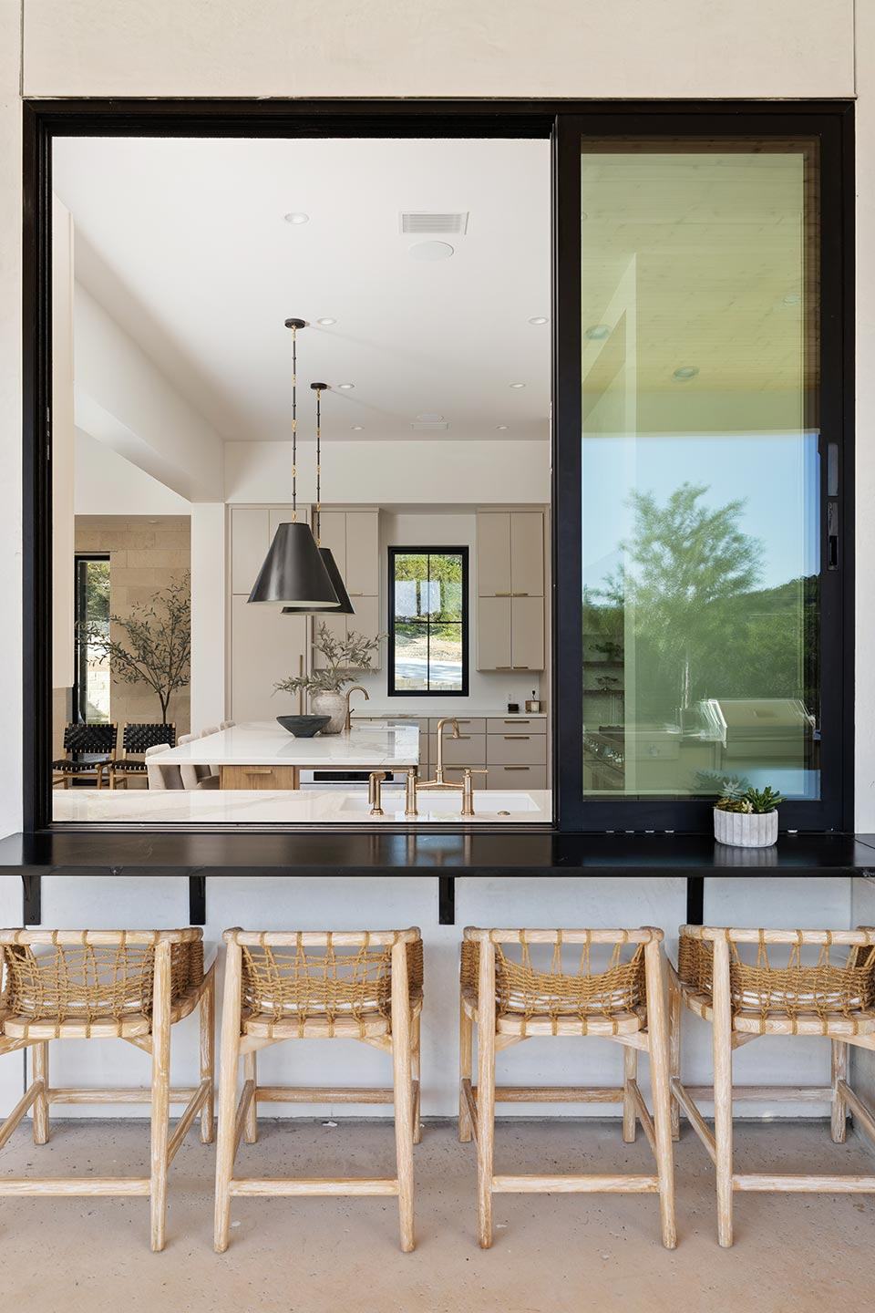 Kitchen with a marble island and pendant lights