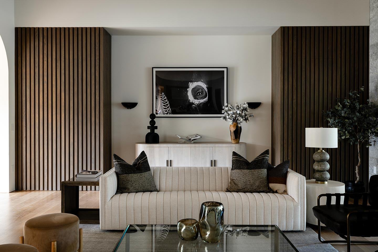 Living room with a wall of glass onto the trees