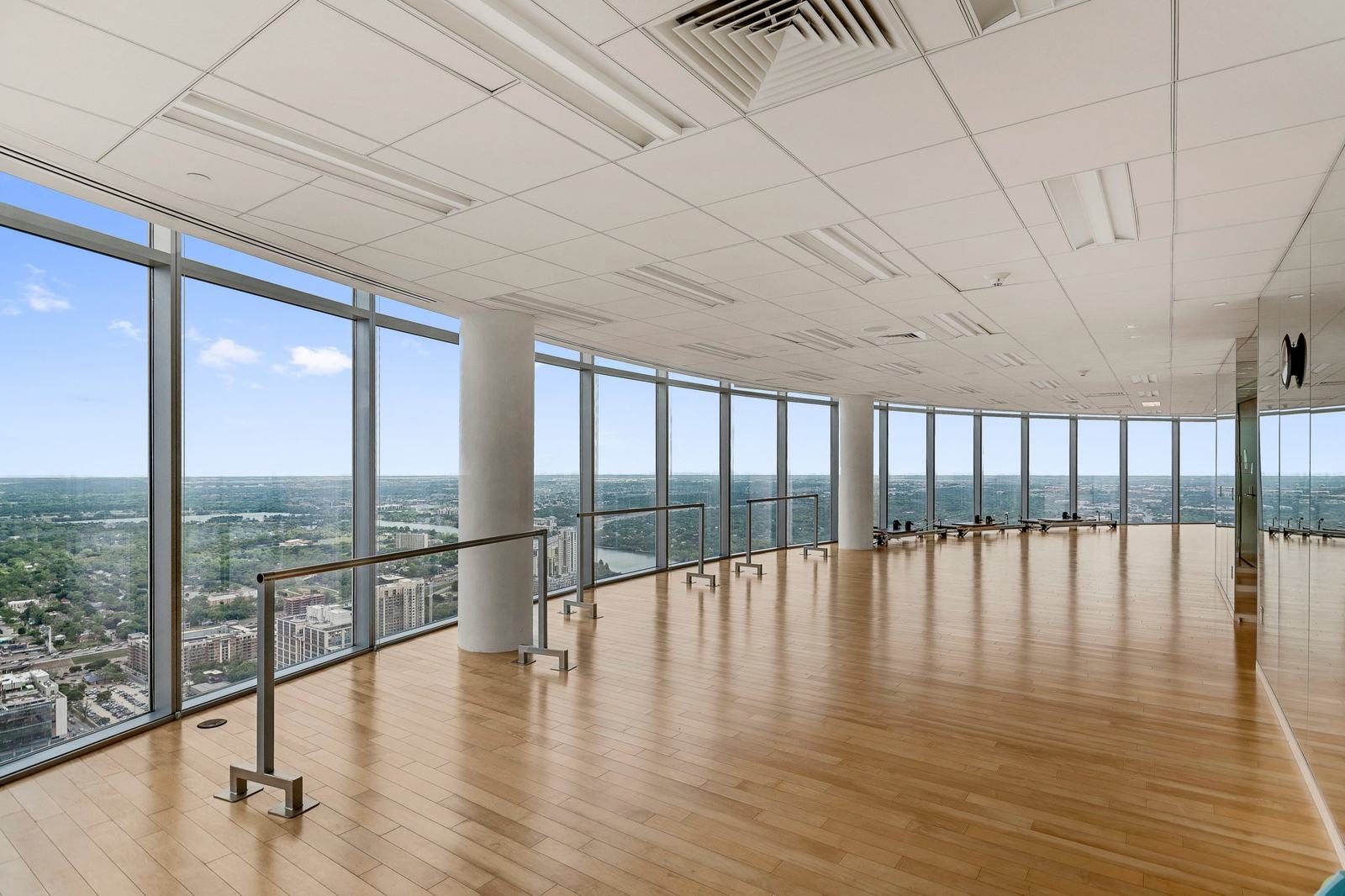 Penthouse floor with curved glass and city views