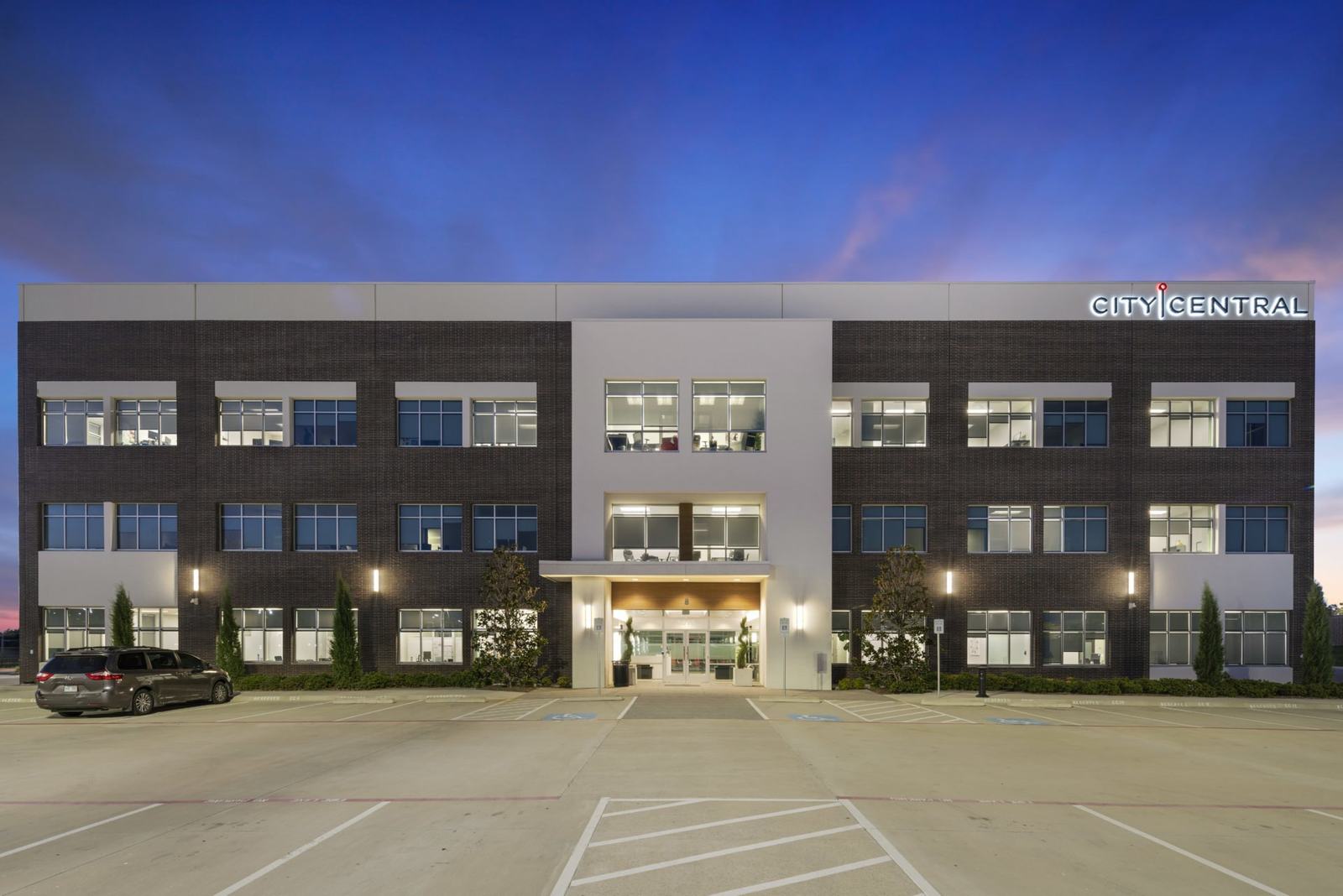 Office building lit at dusk, Spring Creek