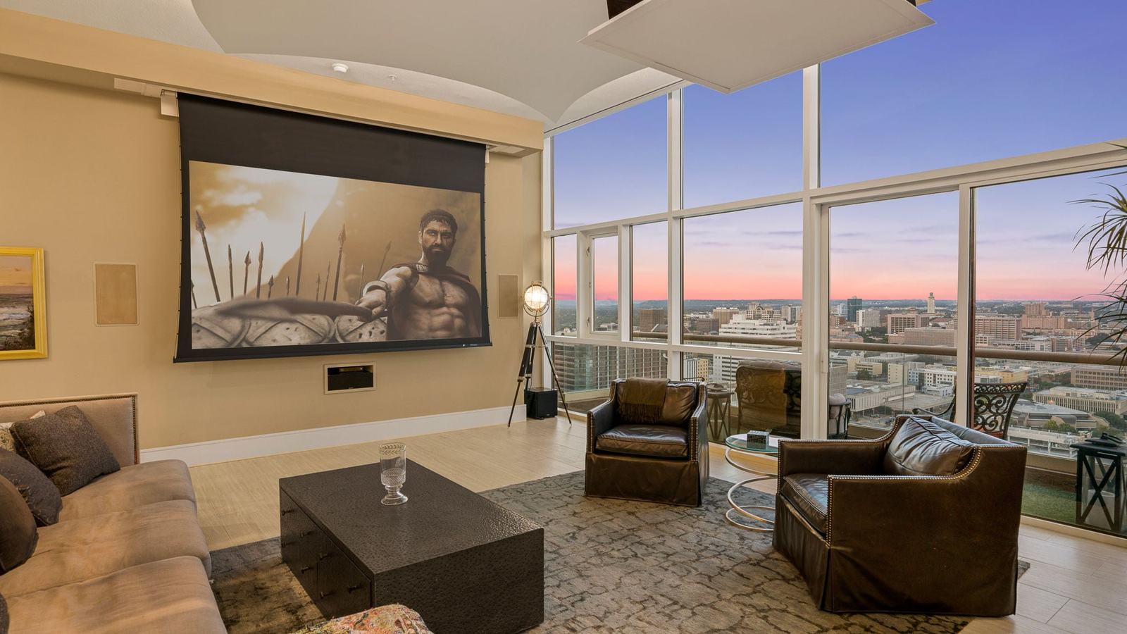 Media room with leather seating and a projector screen