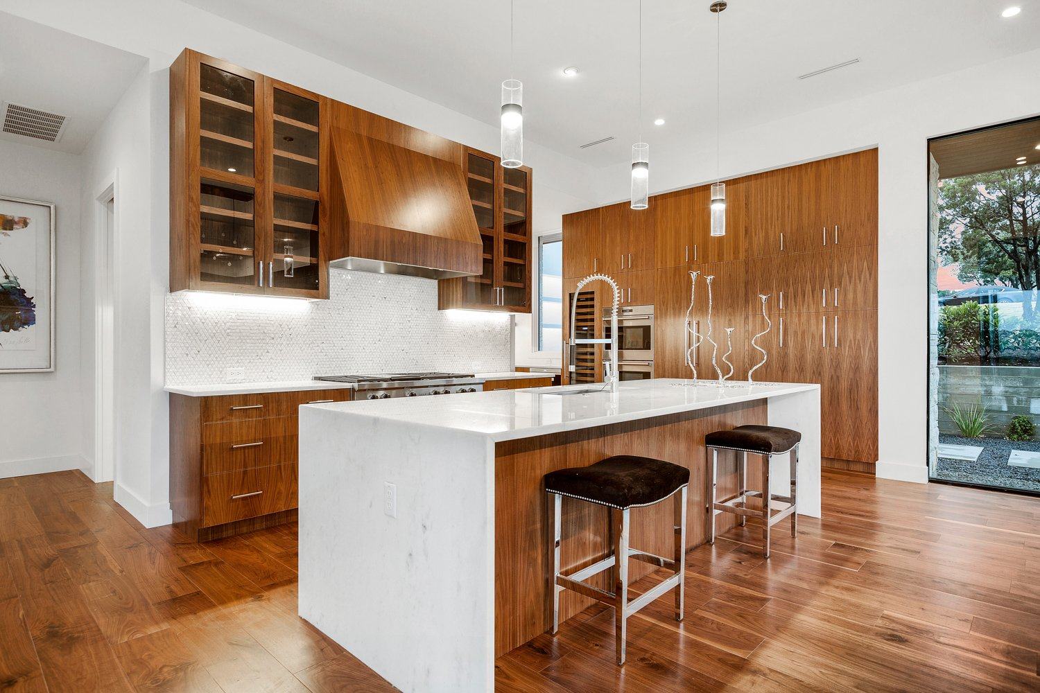 Kitchen with warm wood cabinetry and a marble island