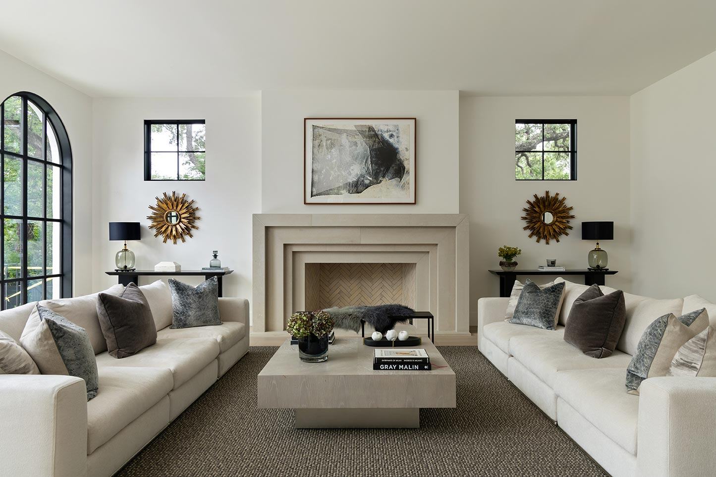 Bright living room with arched windows, styled and lit for a listing
