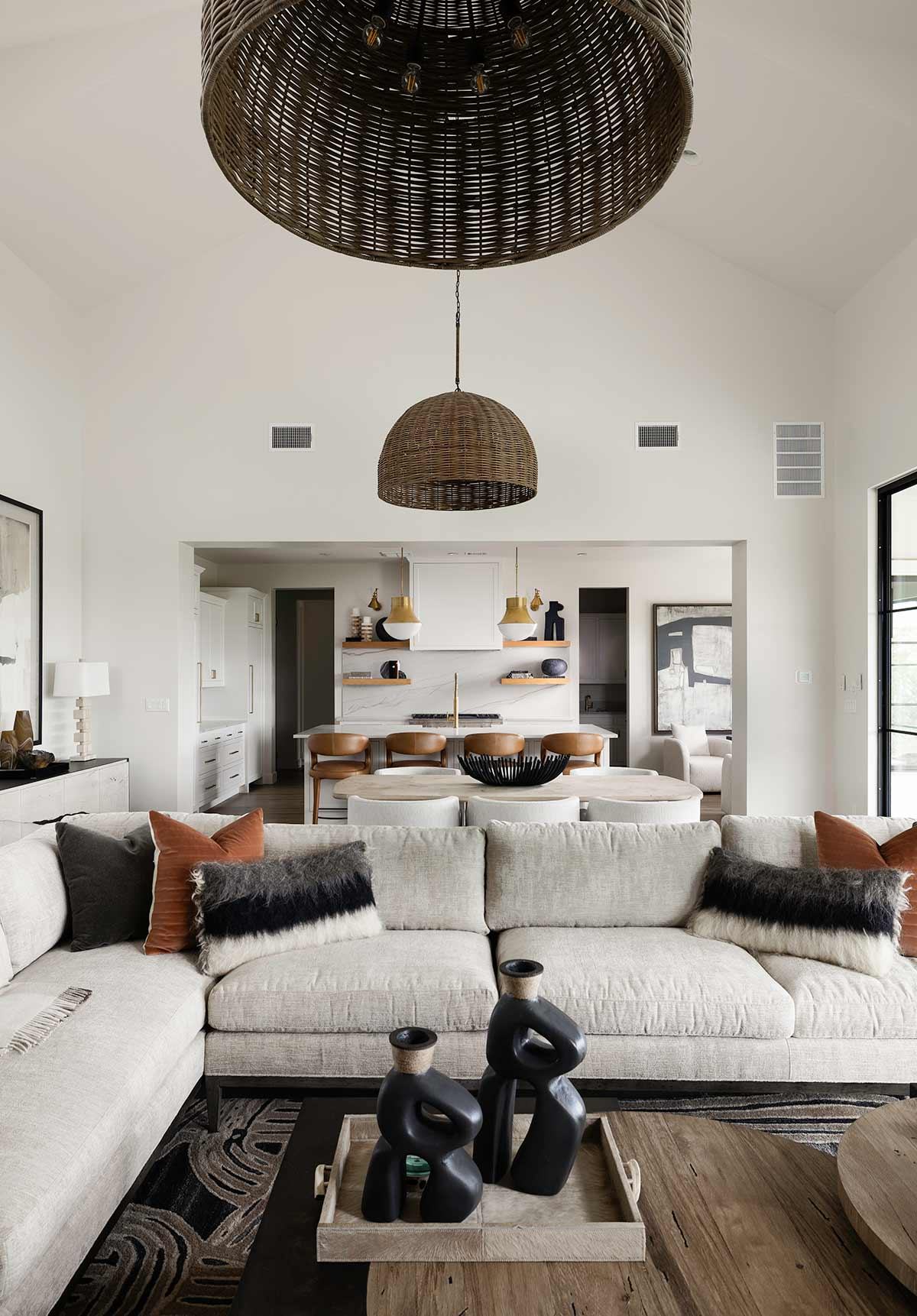 Living room with a vaulted ceiling and a wall of glass
