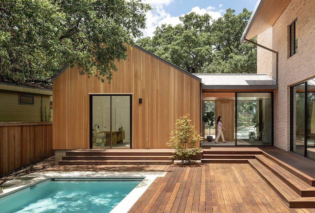 Rear exterior with a pool deck and black cladding