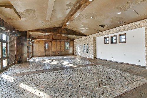Empty living room with a fireplace, before staging