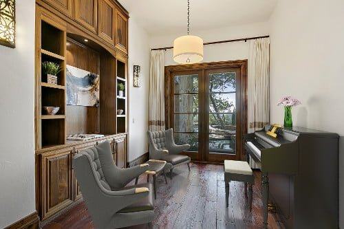 The same room virtually staged with a piano