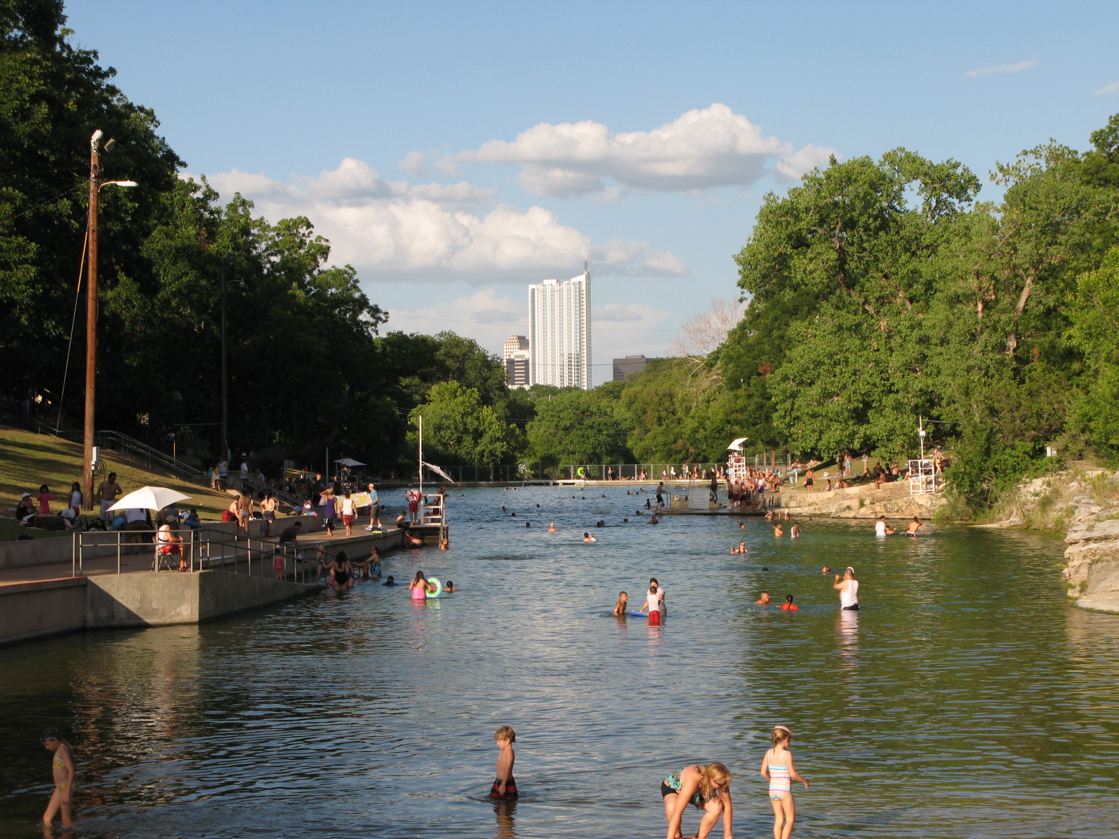 Panoramic view of Barton Springs Pool in Zilker Park Austin Texas on a sunny summer day